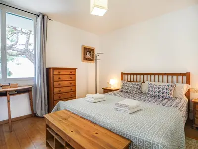 a bedroom with a bed and a desk and a window at Balmins Vibes by Hello Homes Sitges in Sitges