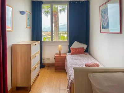 a small bedroom with a bed and a window at Balmins Vibes by Hello Homes Sitges in Sitges