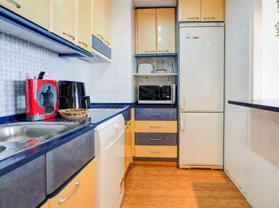 a small kitchen with a sink and a refrigerator at Balmins Vibes by Hello Homes Sitges in Sitges