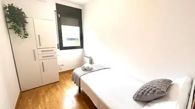 a small bedroom with a bed and a window at Luminoso apartamento by Prestigi in Terrassa