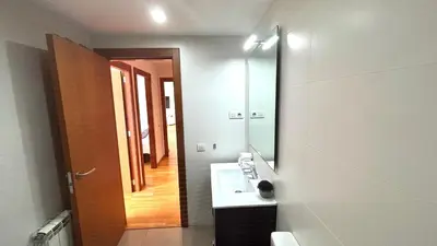 a bathroom with a sink and a large mirror at Luminoso apartamento by Prestigi in Terrassa