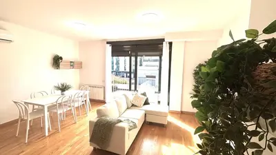 a living room with a couch and a table at Luminoso apartamento by Prestigi in Terrassa
