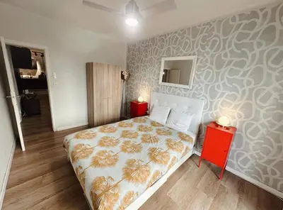 a bedroom with a bed and a red night stand at 2 bedrooms apartment in Barcelona F1 in Hospitalet de Llobregat