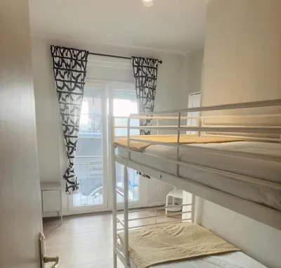 a room with two bunk beds and a balcony at 2 bedrooms apartment in Barcelona F1 in Hospitalet de Llobregat