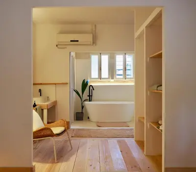 a bathroom with a bath tub and a window at Accommodation in a 13th century Catalan farmhouse in Terrassa