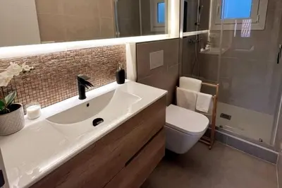 a bathroom with a sink and a toilet and a shower at Sunny & remodeled Apartment in Sant Boi del Llobregat
