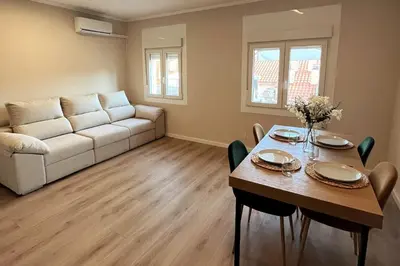 a living room with a table and a couch at Sunny & remodeled Apartment in Sant Boi del Llobregat