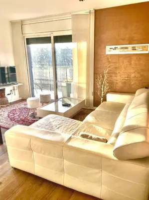 a large white bed in a room with a large window at Ideal for families on the beach in Barcelona with a pool in Badalona