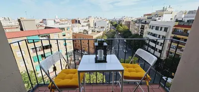 a balcony with a table and chairs and a city at Premium refurbished apartment in Barcelona city center in Barcelona