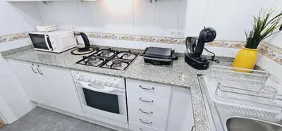 a kitchen with a stove and a microwave on a counter at Premium refurbished apartment in Barcelona city center in Barcelona