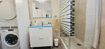 a bathroom with a washing machine and a washer at Premium refurbished apartment in Barcelona city center in Barcelona