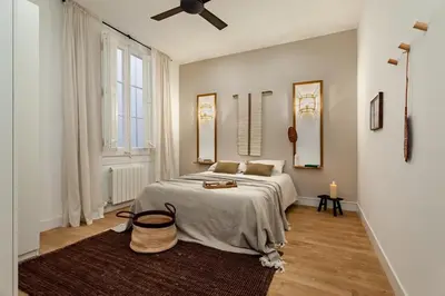 a dining room with a table and two potted plants at Bingin - 3 bedrooms and balcony in Eixample Dreta in Barcelona