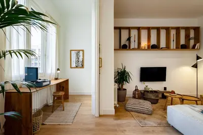 a bedroom with a canopy bed and a potted plant at Bingin - 3 bedrooms and balcony in Eixample Dreta in Barcelona