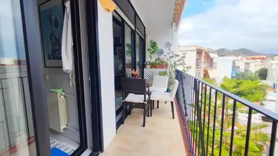 a balcony of a house with a table and chairs at Cosy flat in pretty seaside town in Sitges