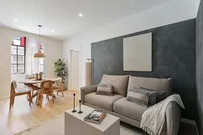 a dining room and living room with a table and chairs at Faro - 2 bedroom in Eixample Esquerra in Barcelona
