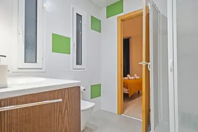 a bathroom with a white sink and a toilet at Click&Flat Gran Via Barcelona in Barcelona