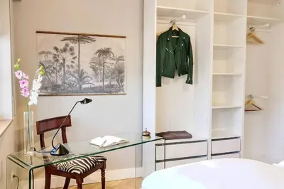a bedroom with a glass desk and a green jacket at Gatsby - 3BR Luxury high floor Terrace by Lilla in Barcelona