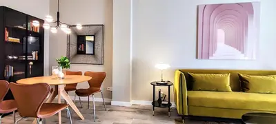 a living room with a yellow couch and a table at Relaxing 3BR w terrace in heart of Gràcia - Bossa in Barcelona