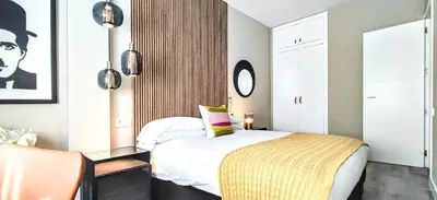 a bedroom with a bed with a yellow blanket at Relaxing 3BR w terrace in heart of Gràcia - Bossa in Barcelona