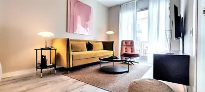 a living room with a yellow couch and a chair at Relaxing 3BR w terrace in heart of Gràcia - Bossa in Barcelona