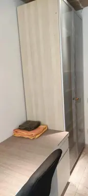 a room with a bed with a laptop on it at Habitación en piso compartido in Terrassa