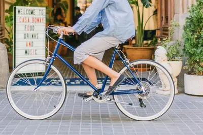 a person riding a blue bike on a street at Hotel Casa Bonay & Spa in Barcelona