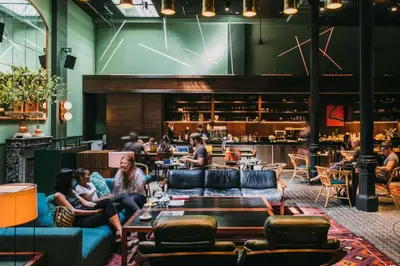 a group of people sitting on couches in a restaurant at Hotel Casa Bonay & Spa in Barcelona