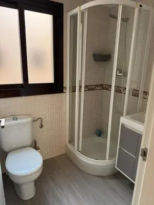 a bathroom with a toilet and a shower at Atico espectacular Cunit in Cunit