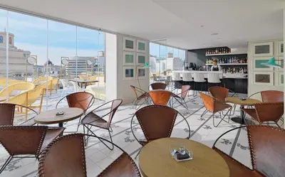a restaurant with tables and chairs on a balcony at H10 Cubik 4* Sup in Barcelona
