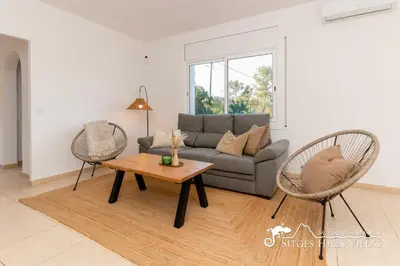 a bedroom with a bed and a mirror at Sunny Villa Moments near Sitges in Olivella