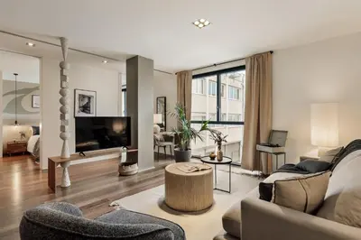 a bedroom with a large bed with a painting on the wall at Cabuy - 1 bedroom in La Dreta de l'Eixample in Barcelona