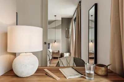 a table with a lamp and plants on it at Cabuy - 1 bedroom in La Dreta de l'Eixample in Barcelona