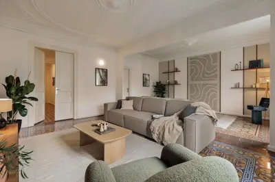 a bedroom with a large bed and a table at Mirra - 5 bedrooms and terrace in Eixample Dreta in Barcelona