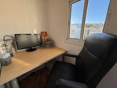 a desk with a computer monitor and a chair at Full flat in the heart of Barcelona in Barcelona