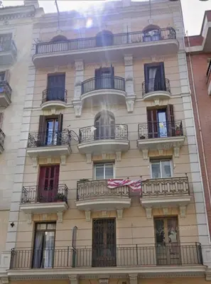 an apartment building with balconies on a city street at Full flat in the heart of Barcelona in Barcelona