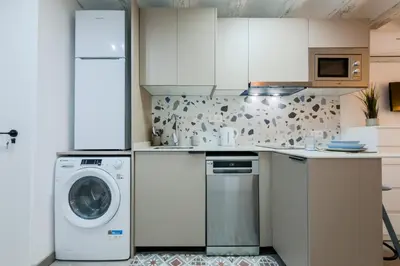 a kitchen with a washing machine and a washer at Acogedor y céntrico Estudio 1 in Barcelona