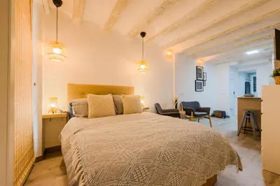 a bedroom with a bed and a desk and chairs at Acogedor y céntrico Estudio 2 in Barcelona