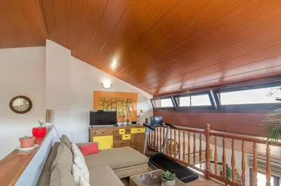 a living room with a couch and a wooden ceiling at Casa con piscina salina a 5 minutos de Sitges in Canyelles