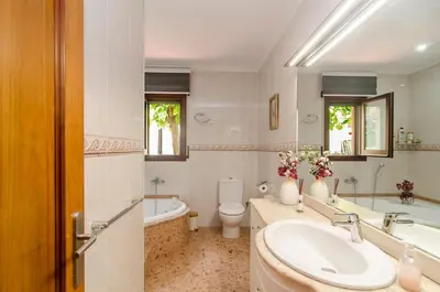 a bathroom with a sink and a tub and a toilet at Casa con piscina salina a 5 minutos de Sitges in Canyelles