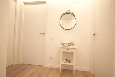 a white room with a mirror and a table at Rooftop pool near the beach and Barcelona in Masnou