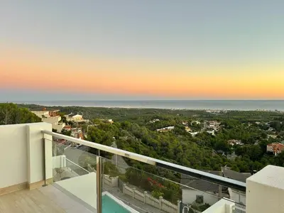 a view of the ocean from the balcony of a house at Les Flors de Cunit Villa Edelweiss in Cunit