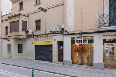 an empty city street with a building at matarolux21 in Mataró