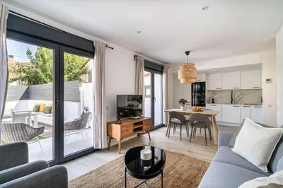 a living room with a couch and a table at The Sweet House - BBQ y piscina in Sant Cugat del Vallès