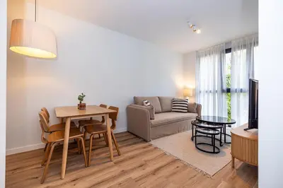 a living room with a table and a couch at Brabo Apartments in Hospitalet de Llobregat