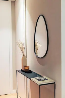 a mirror on a wall next to a table at Brabo Apartments in Hospitalet de Llobregat