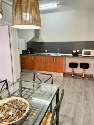 a kitchen with a glass table with a plate of food on it at Apartamento vacaciones Barcelona in Barcelona