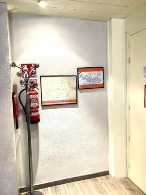 a room with two pictures on the wall and a fire extinguisher at Apartamento vacaciones Barcelona in Barcelona