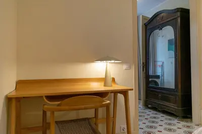 a desk with a lamp and a chair in a room at 