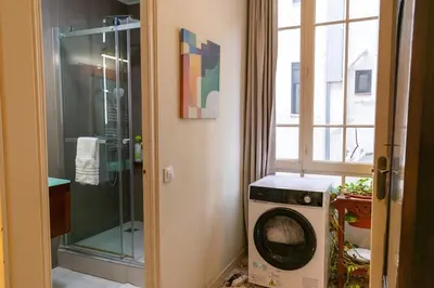 a washer and dryer in a bathroom with a window at 