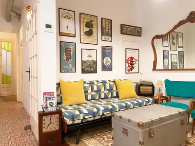 a living room with a couch and pictures on the wall at Vintage home in Barcelona
